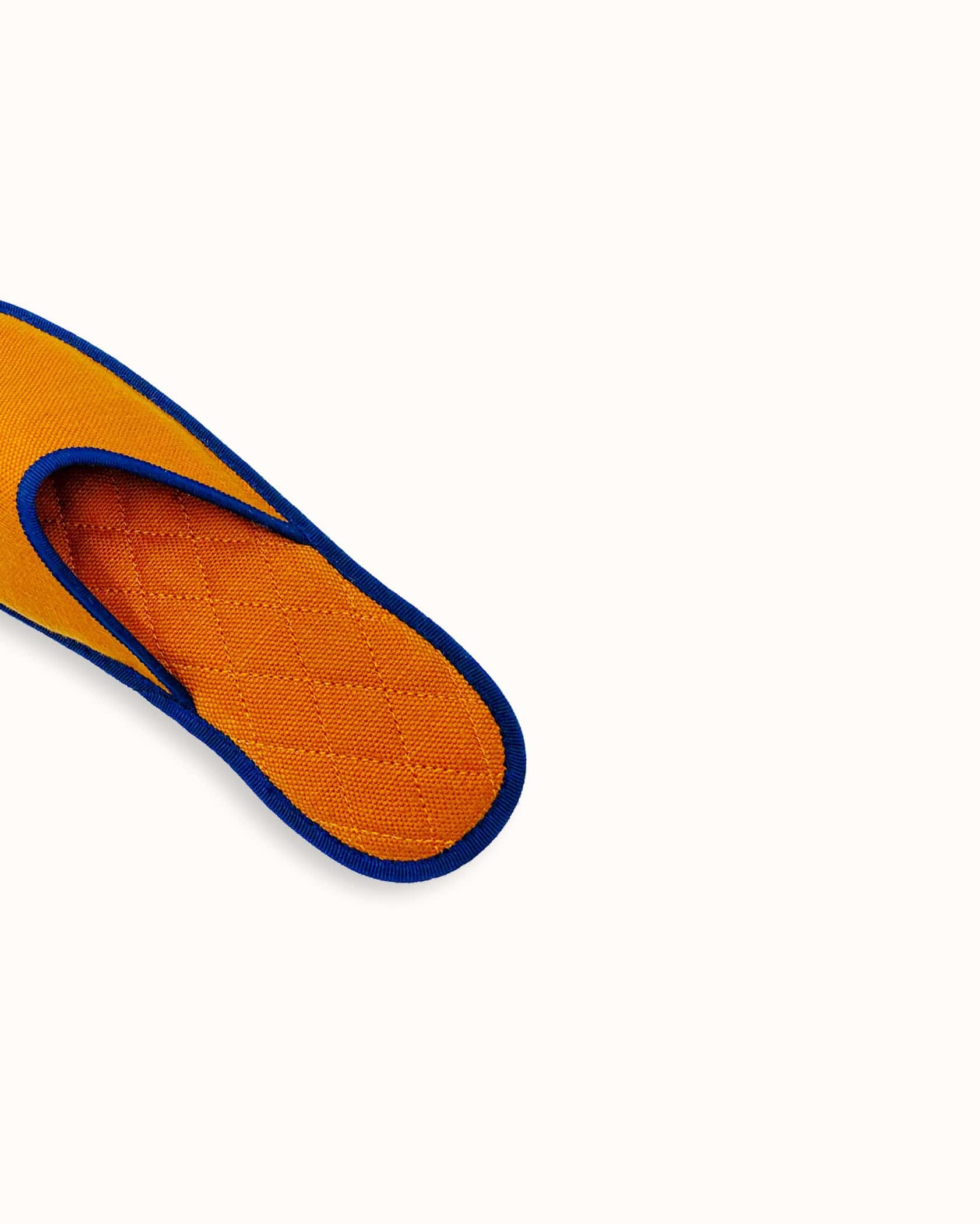 French slippers for men, women and kids. Le Spleen "Feu", orange and navy blue. A slip-on like hotel slippers with a quilted padding and an outstanding craftsmanship manufacturing. Made in France.